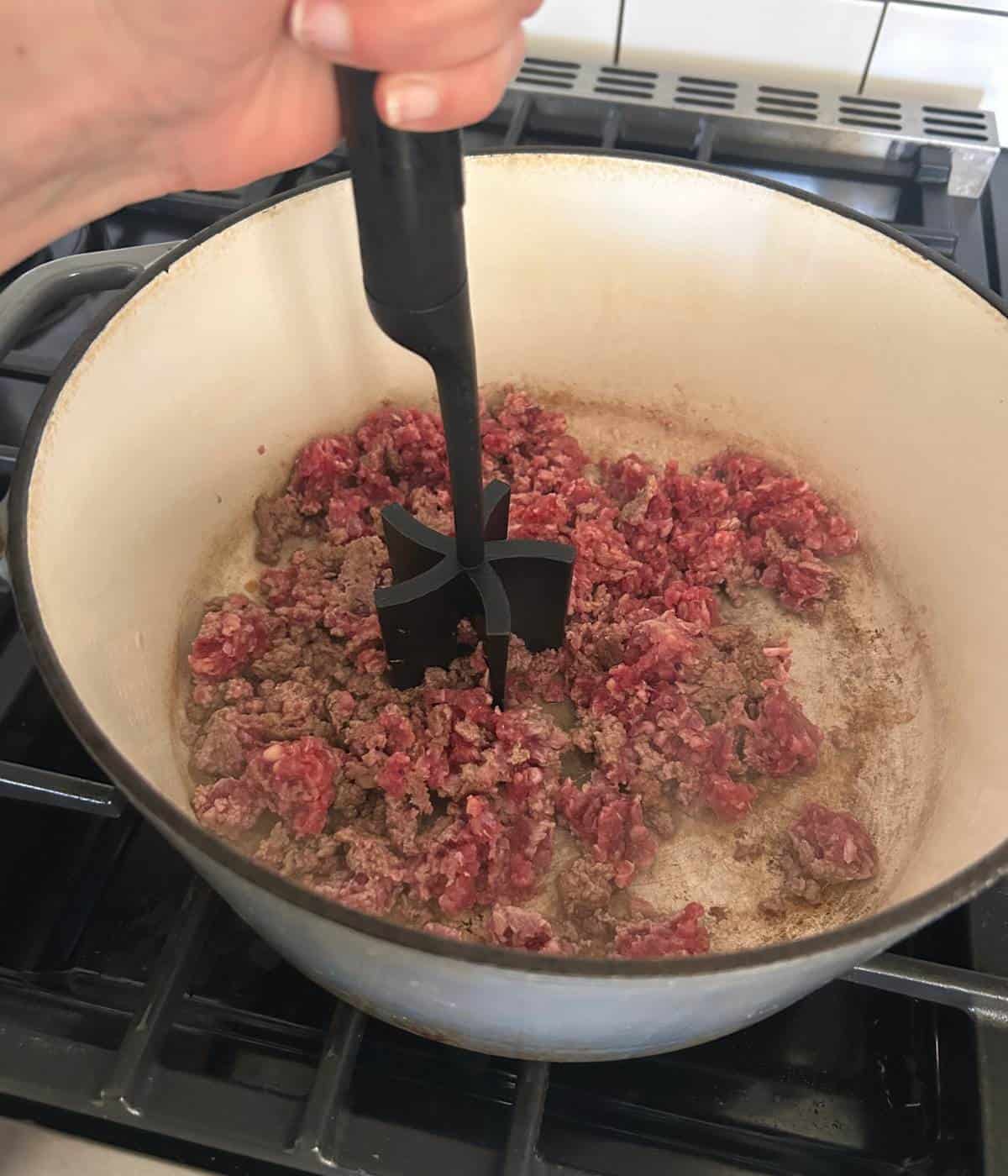 Ground beef in pot.