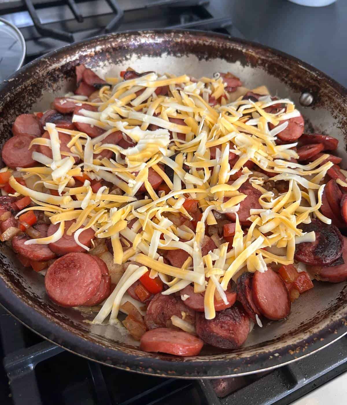 Kiebasa and cheese over top of pierogies.