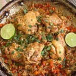 Chicken thighs with rice topped with cilantro and lime.