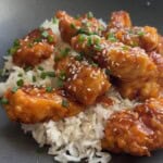 Crispy orange chicken over rice.