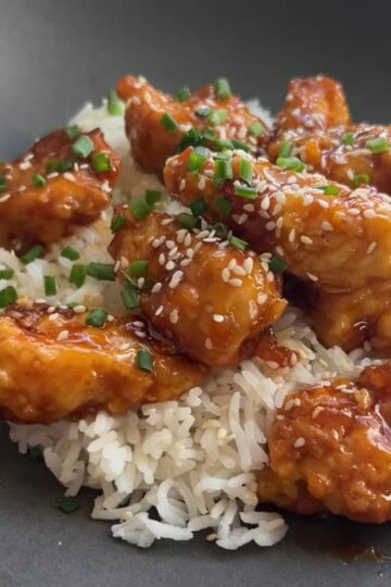 Crispy orange chicken over rice.