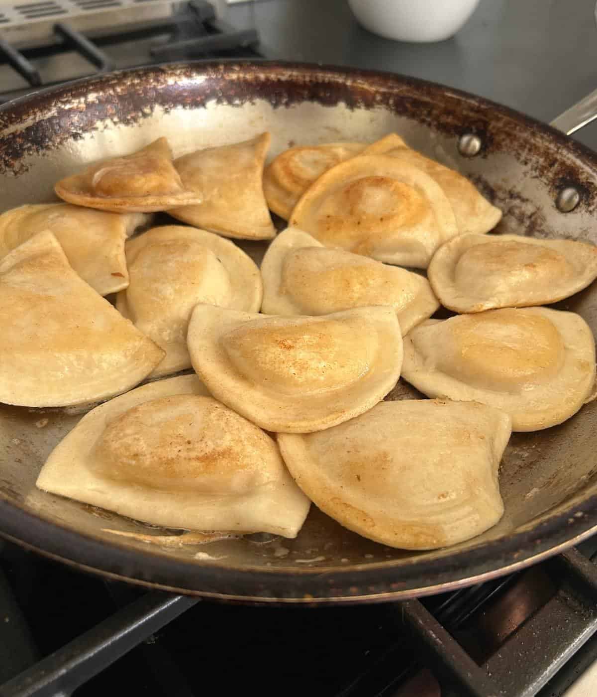Frying pierogies in butter.