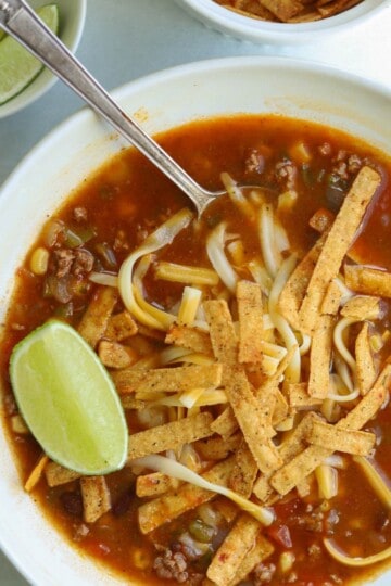 Taco soup recipe topped with tortilla strips.