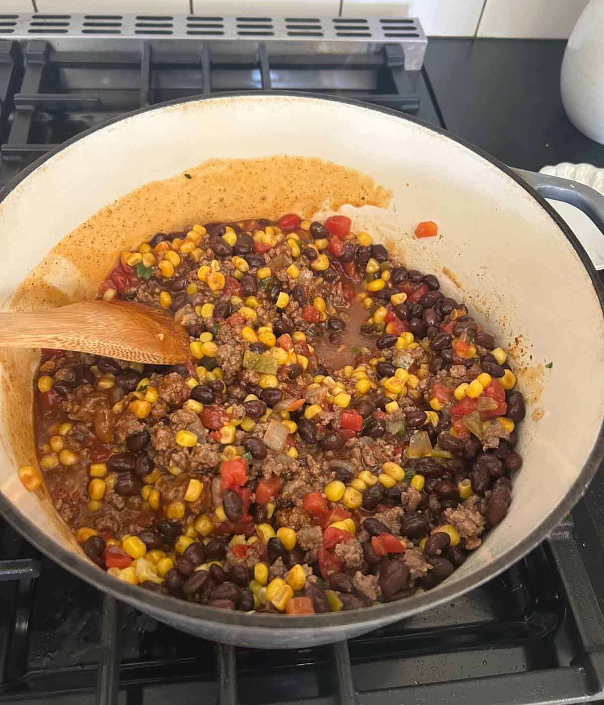 Beef, beans, and corn in pot.