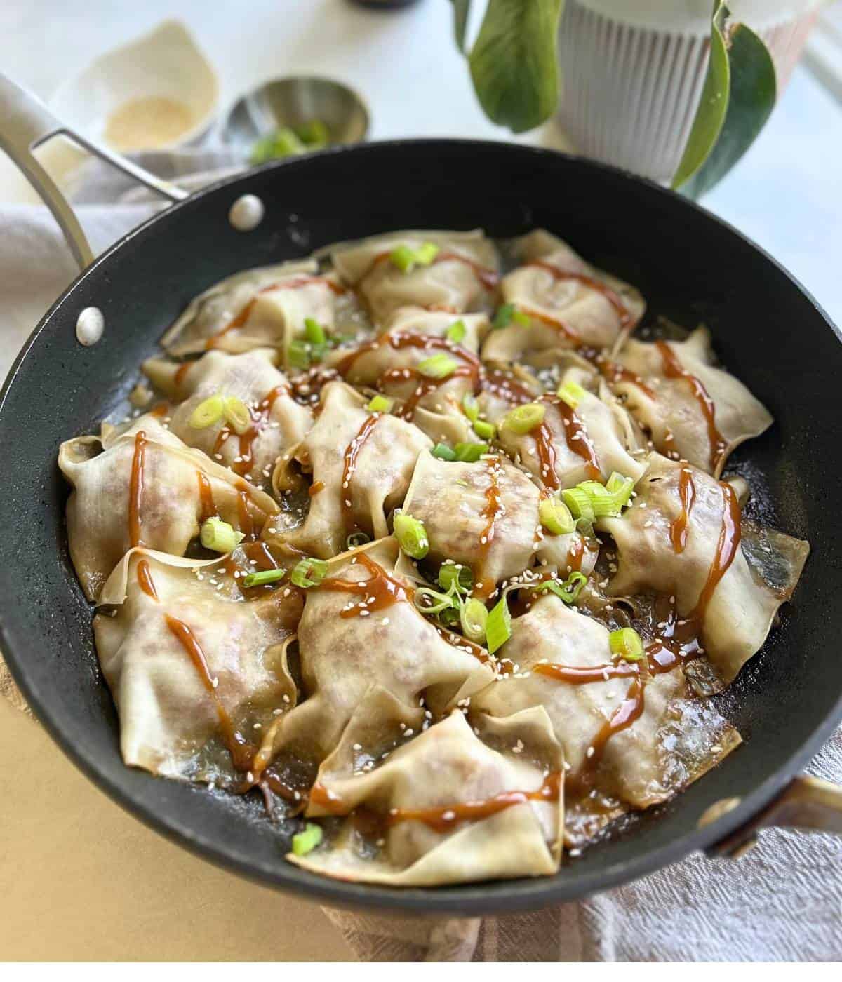 Pork dumplings topped with peanut sauce. 