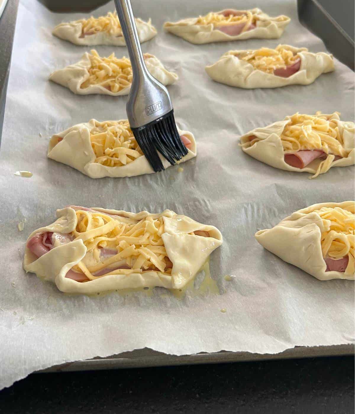 Brushing egg wash on puff pastry.