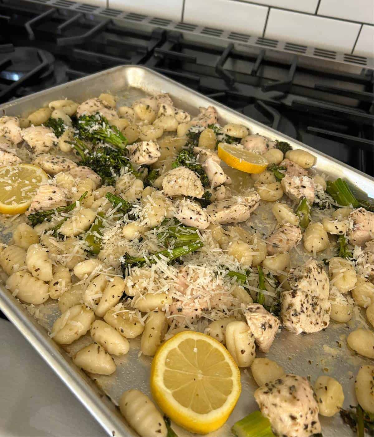 Tossing garlic butter into ingredients and adding parmesan.