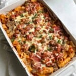 Rigatoni and sausage in casserole dish.