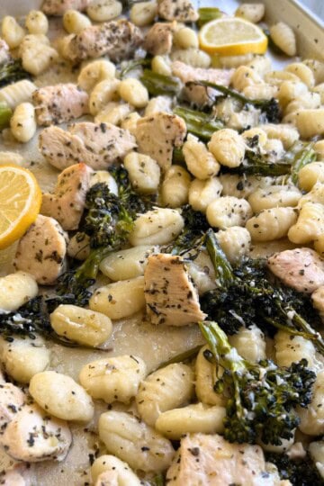 Gnocchi, broccolini and chicken on cookie sheet.