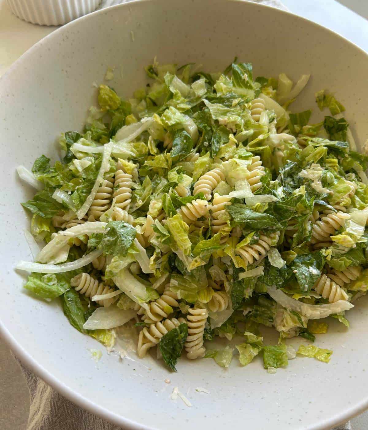 Assembling the Caesar Salad in a bowl.