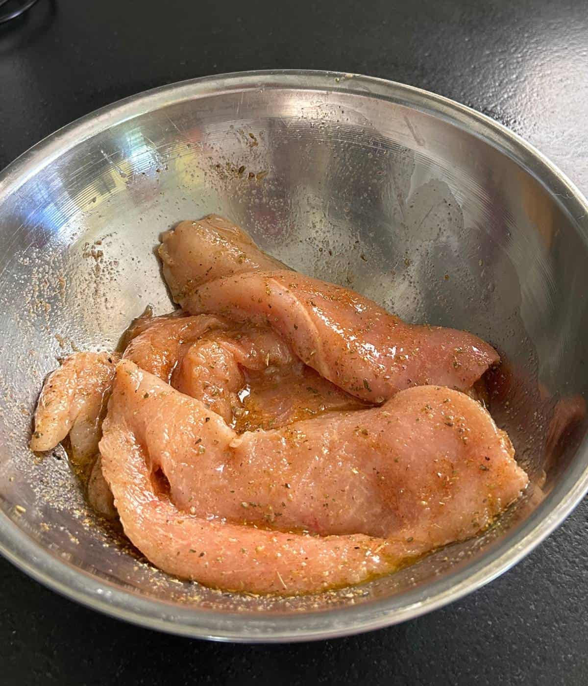 Chicken breast marinating in pepperoncini juices.