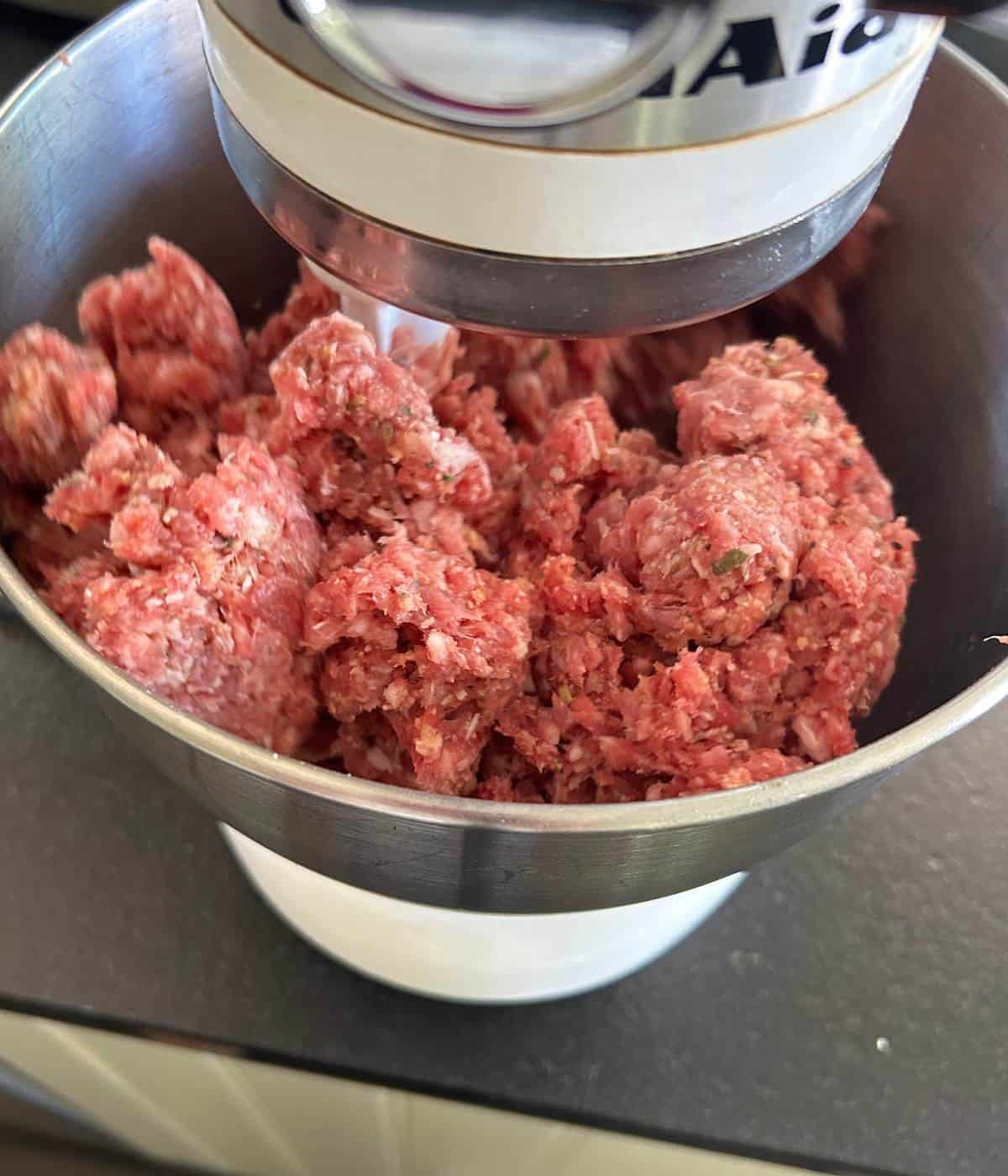 Meatball mixture combining in stand mixer.