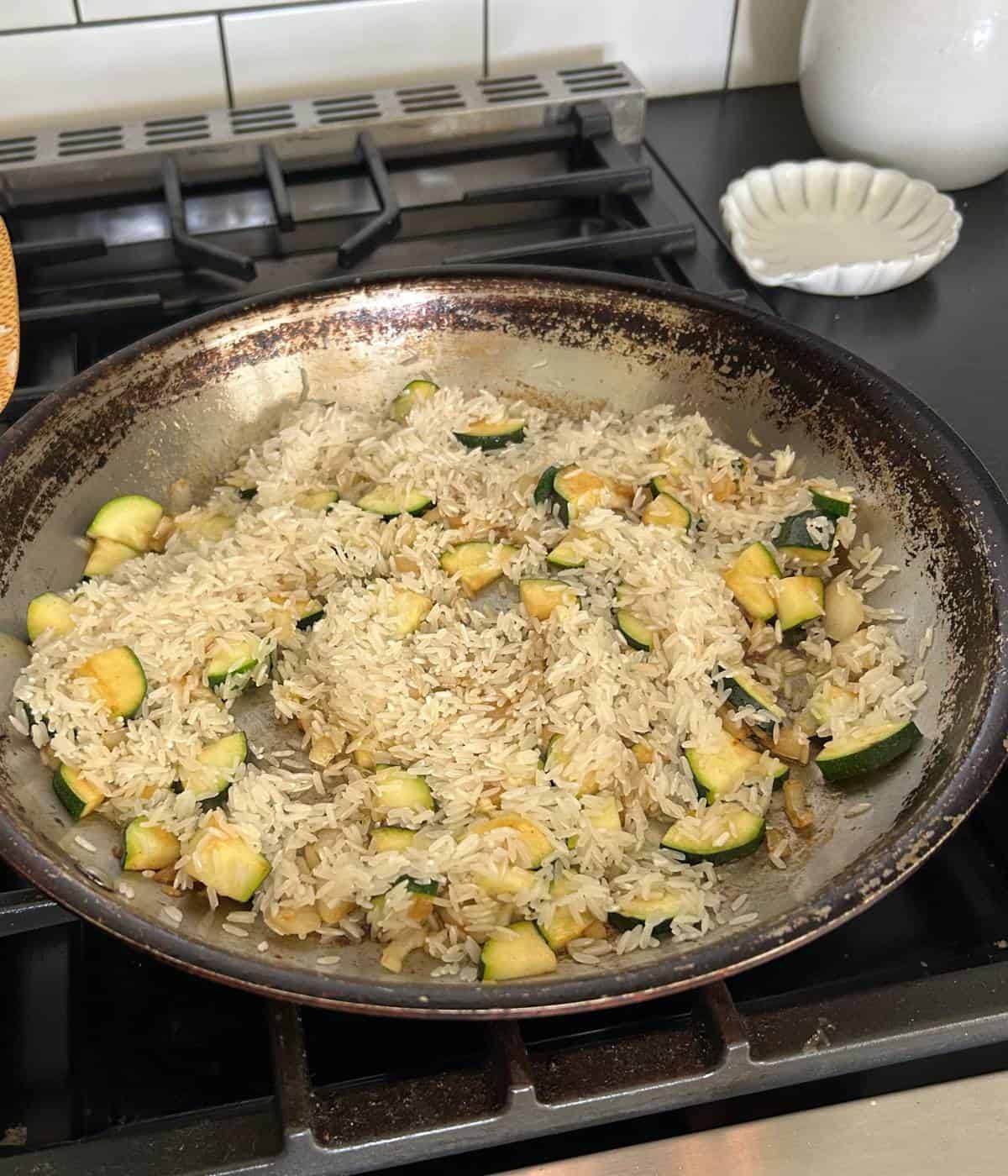 Veggies and rice in skillet.