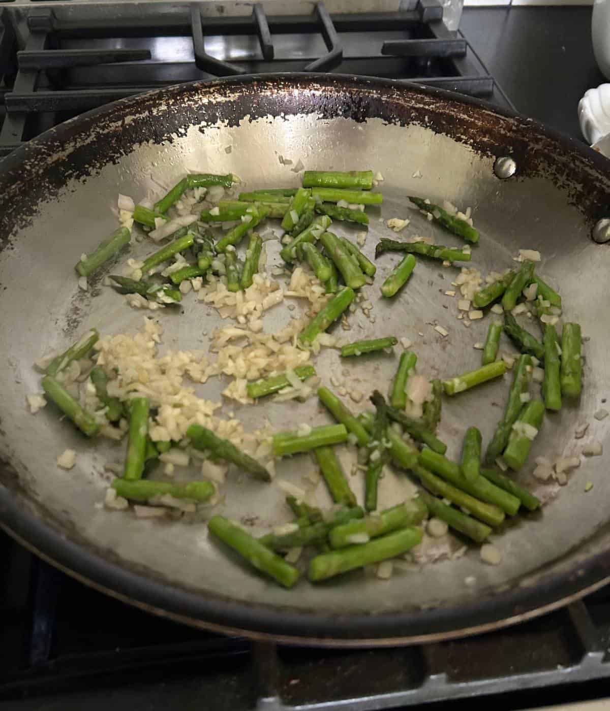 Asparagus shallot and garlic in skillet.