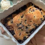 Blueberry dump cake with lemon whipped cream on the side.