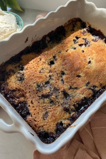 Blueberry dump cake with lemon whipped cream on the side.