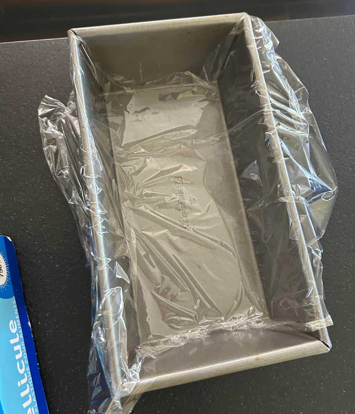 Plastic wrap lining bread pan.