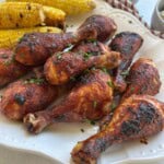 BBQ chicken drumsticks on platter.