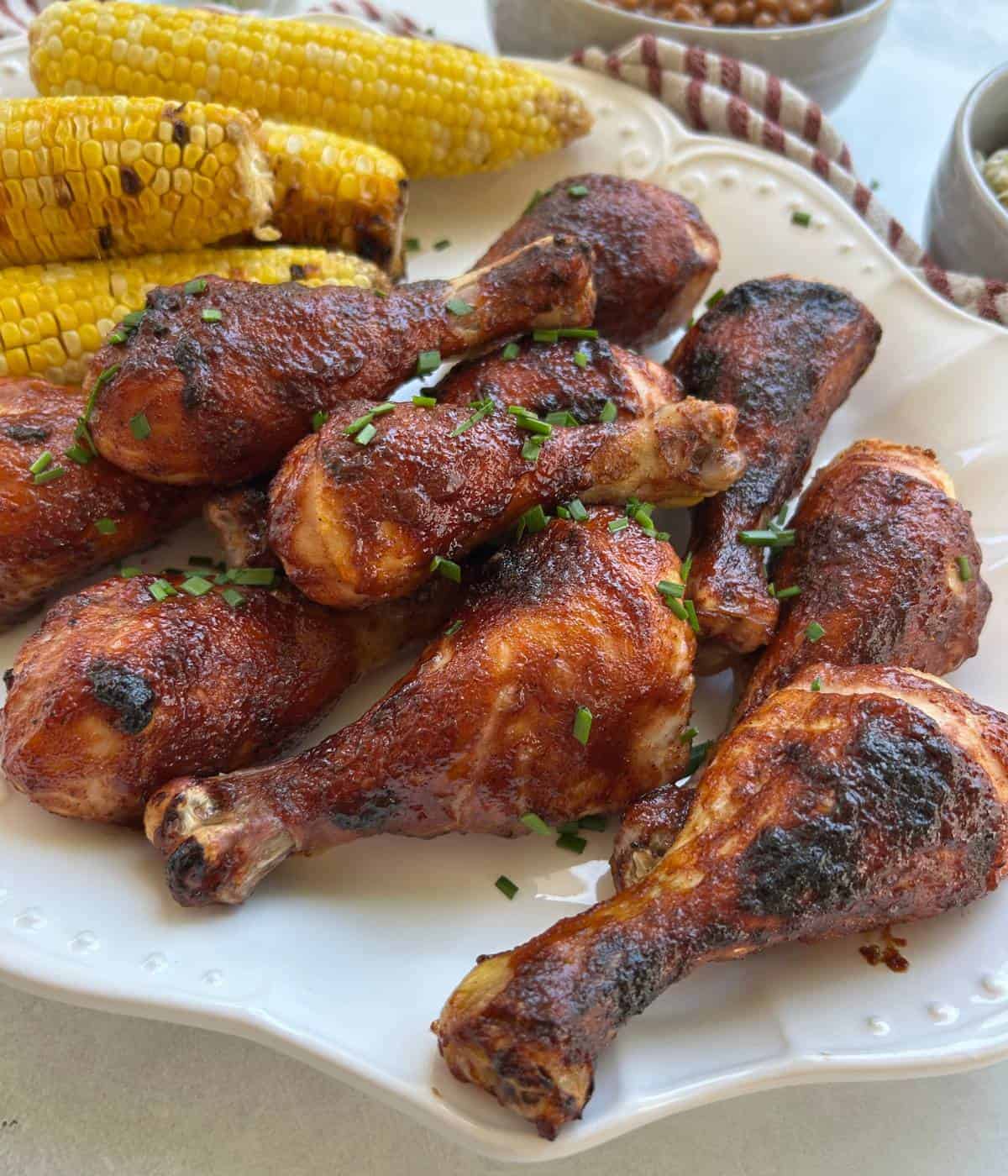 BBQ chicken drumsticks on platter.
