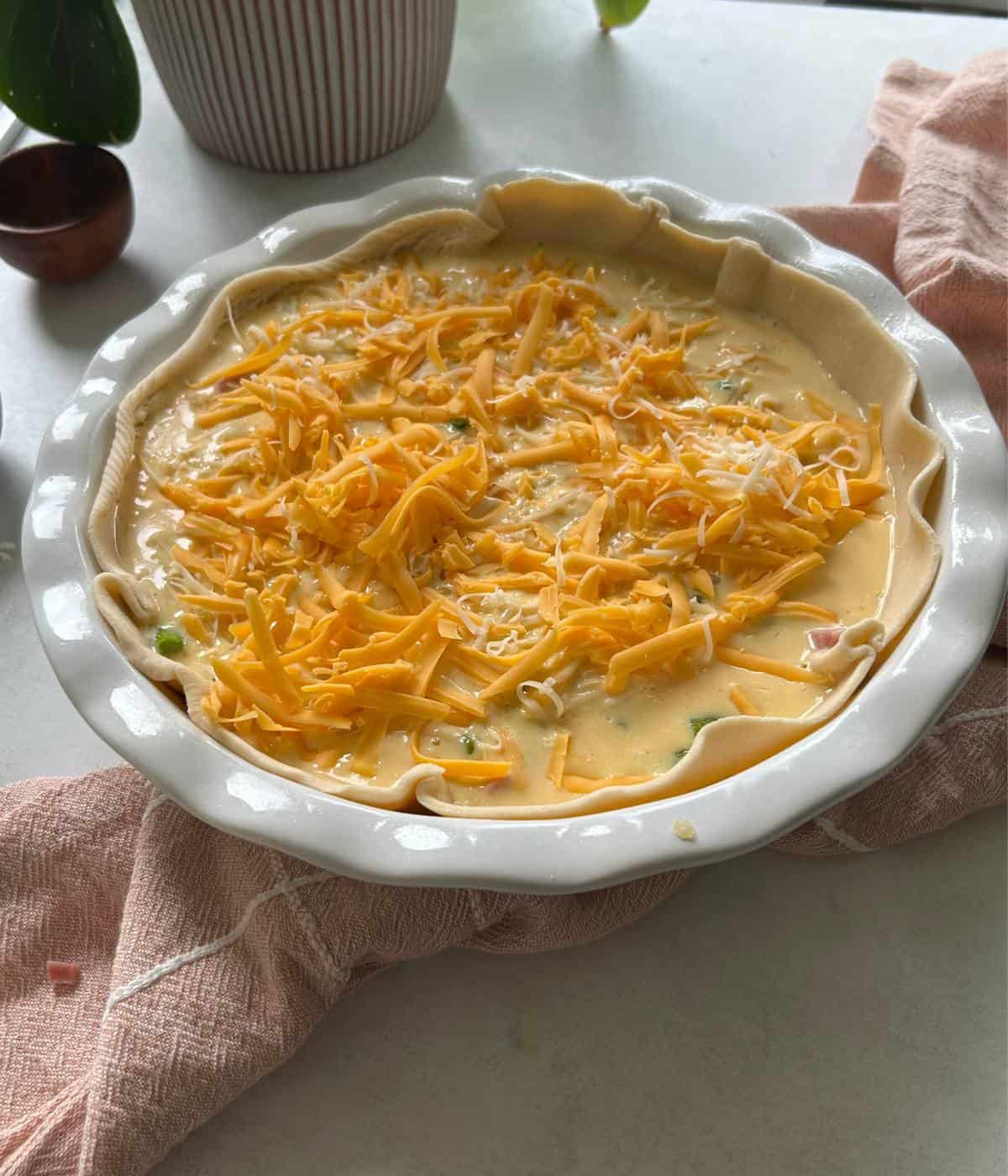 Unbaked quiche with filling.