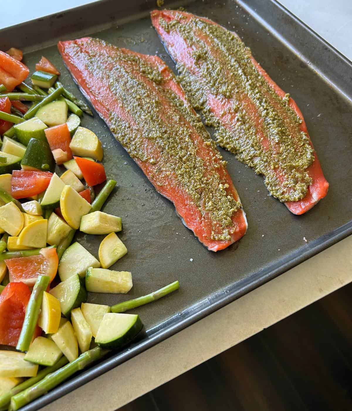 Pesto spread onto salmon.