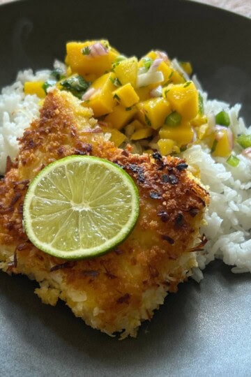 Crusted panko cod with rice and Mango Pico De Gallo in bowl.
