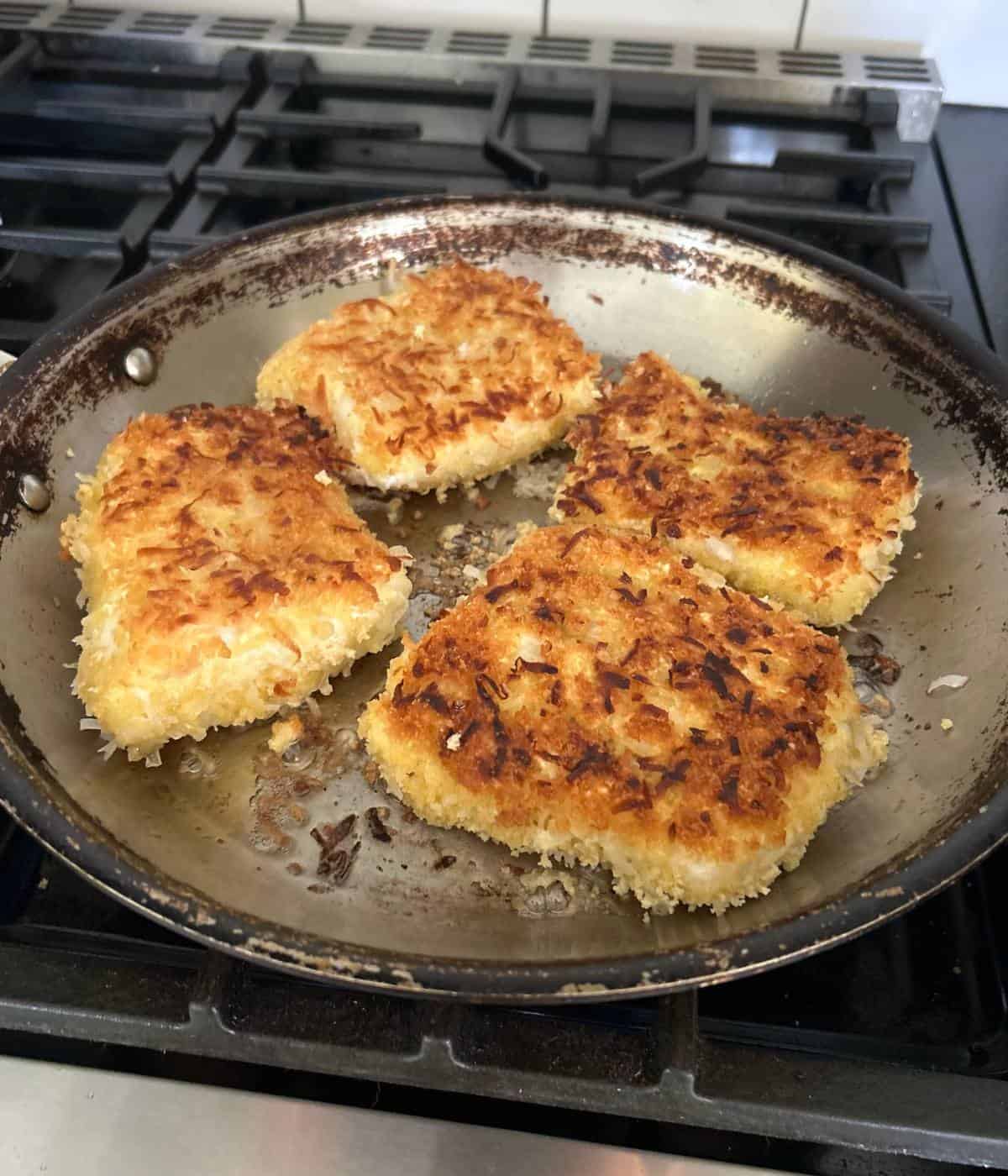Pan frying fish.