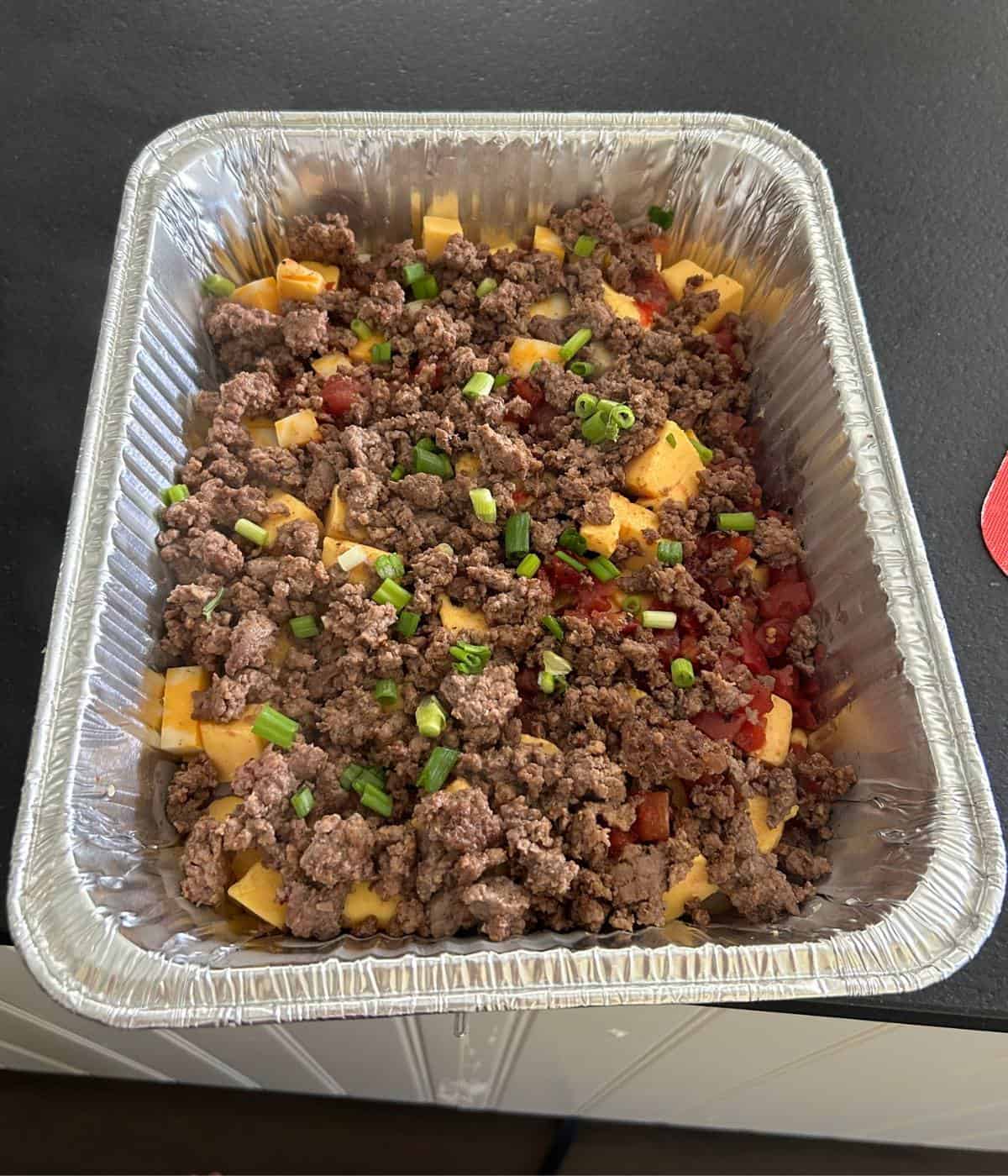 Smoked queso in aluminum pan.