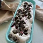 Cherry vanilla ice cream in tub.