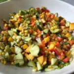 Corn and peach salad in serving bowl.