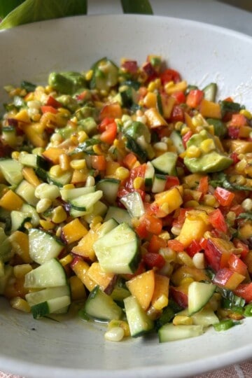 Corn and peach salad in serving bowl.