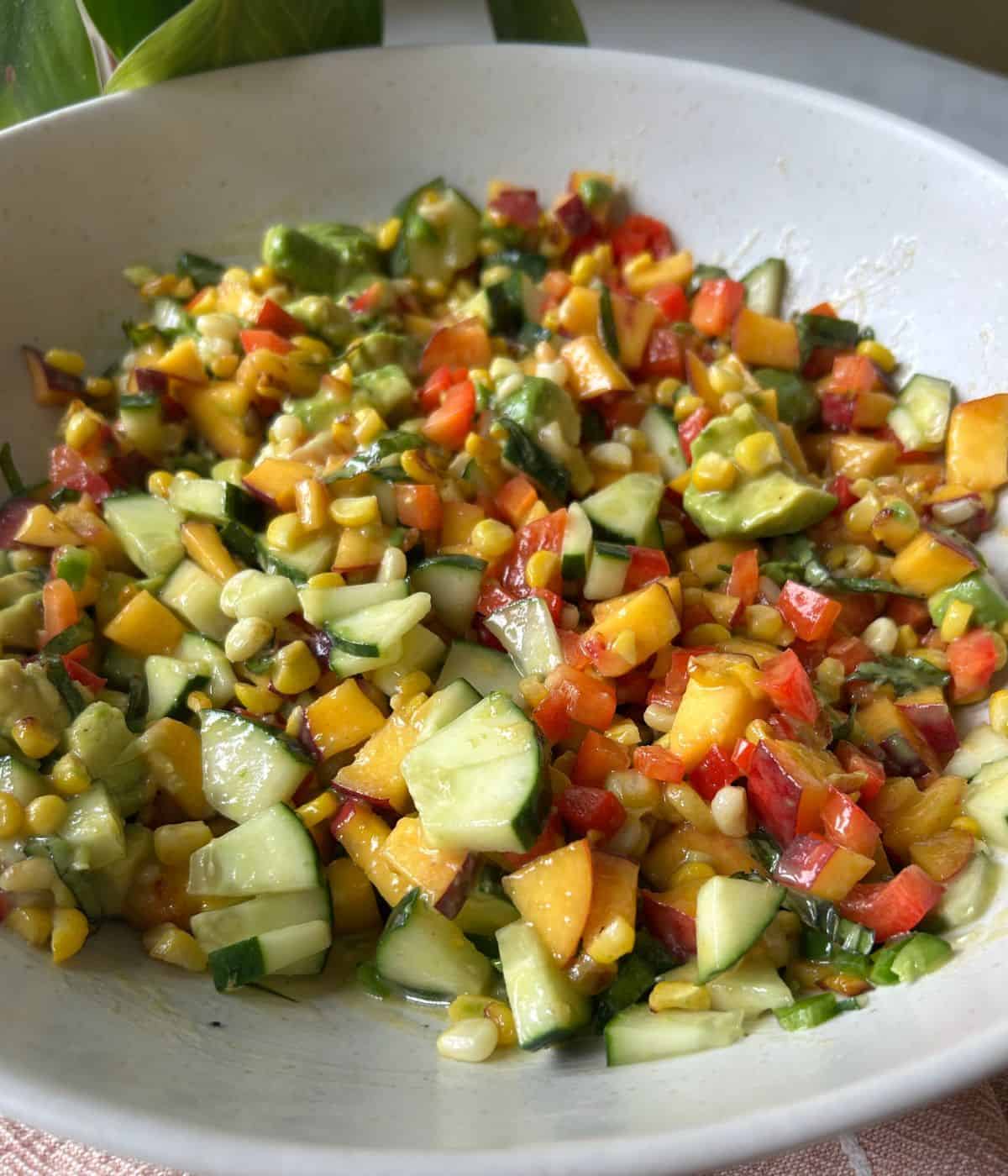 Corn and peach salad in serving bowl.