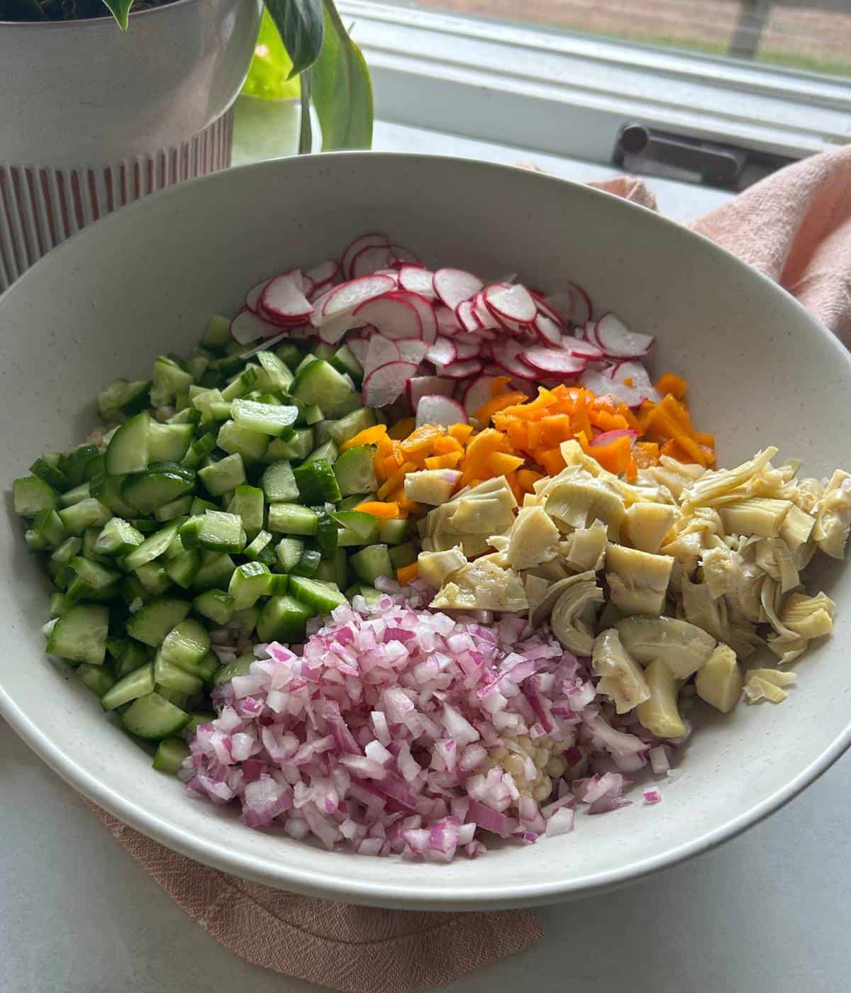 Couscous salad ingredients in bowl.