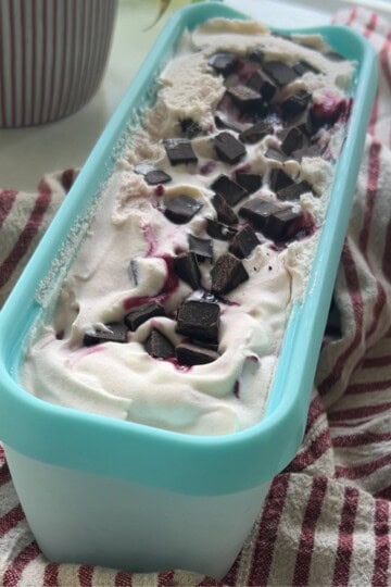 Cherry vanilla ice cream in tub.