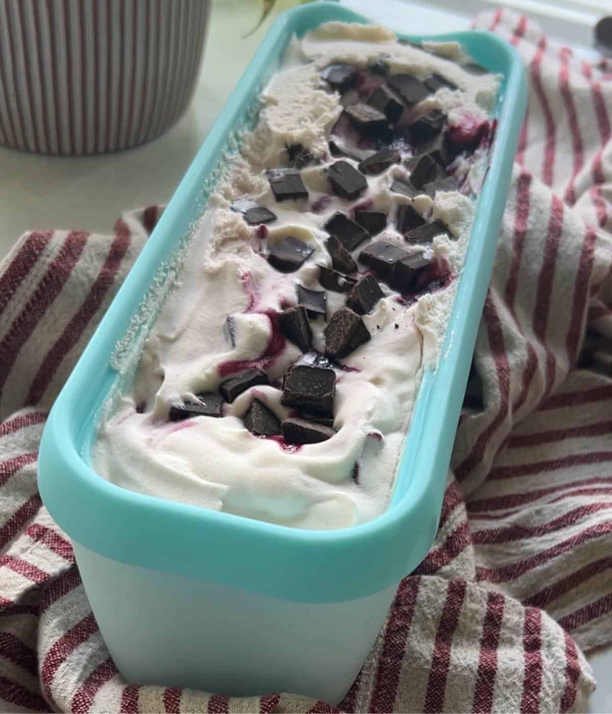 Cherry vanilla ice cream in tub.