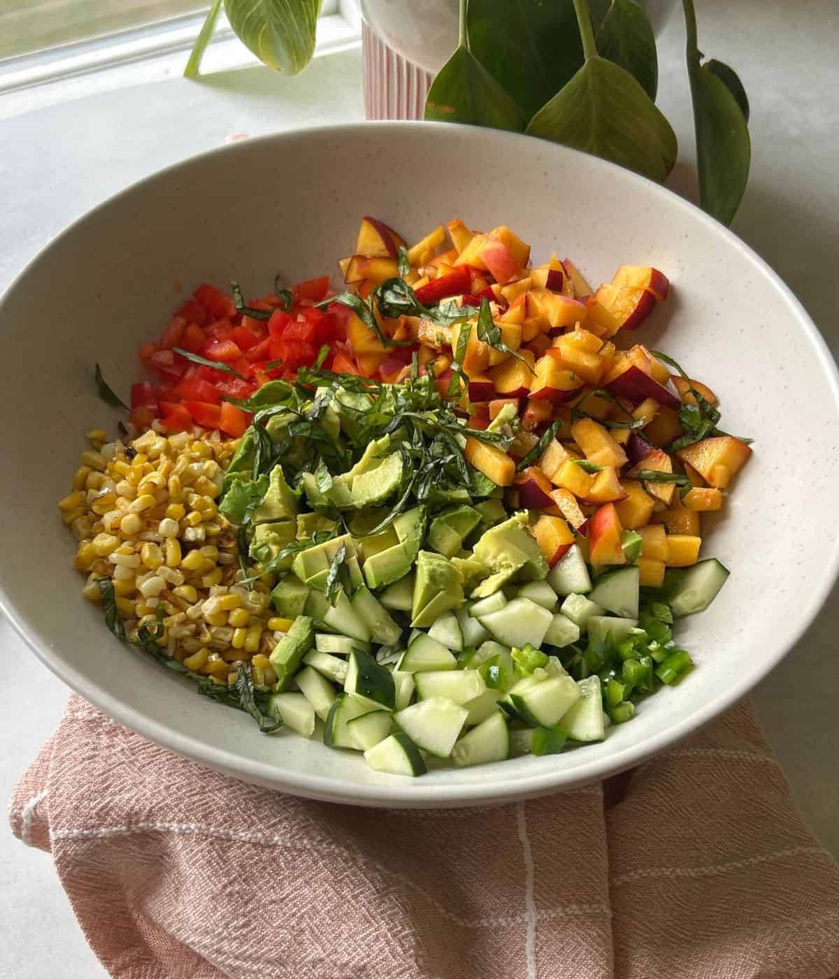 Peach and corn salad in bowl.