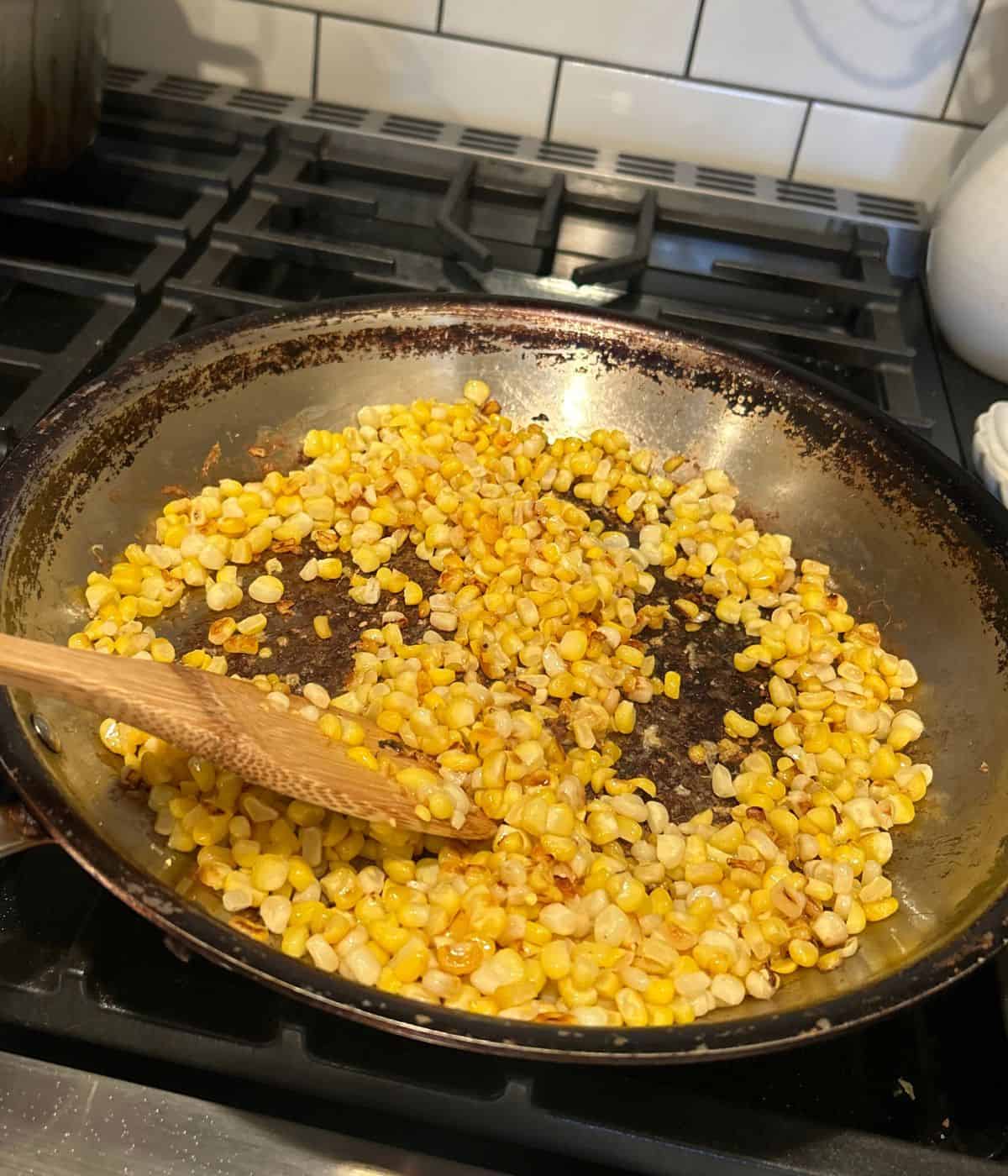 Corn cut off the cob cooking in skillet.