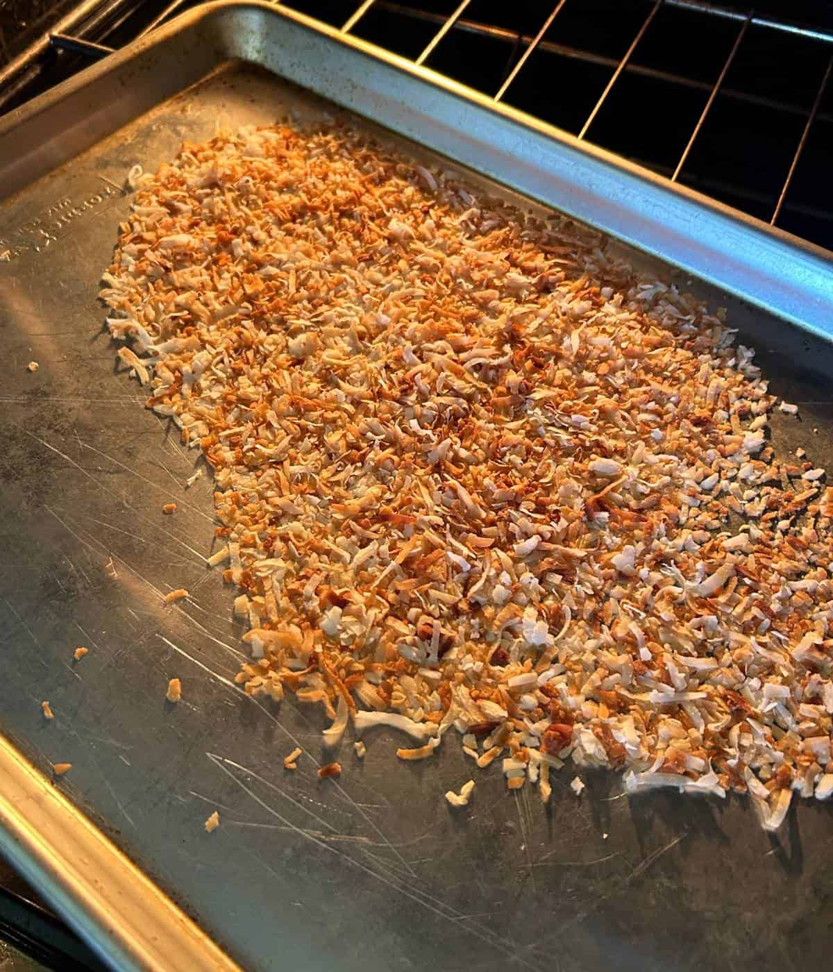 Toasted coconut on cookie sheet.
