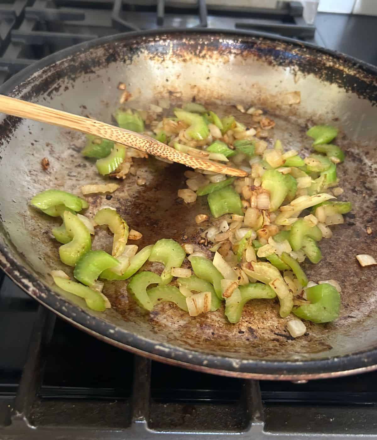 Veggies sautéing in skillet for beef broth bowls.