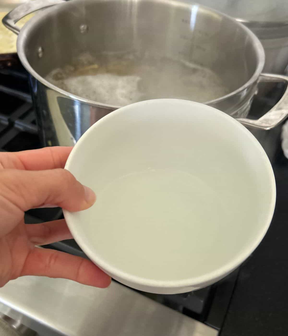 Reserved pasta water in bowl.