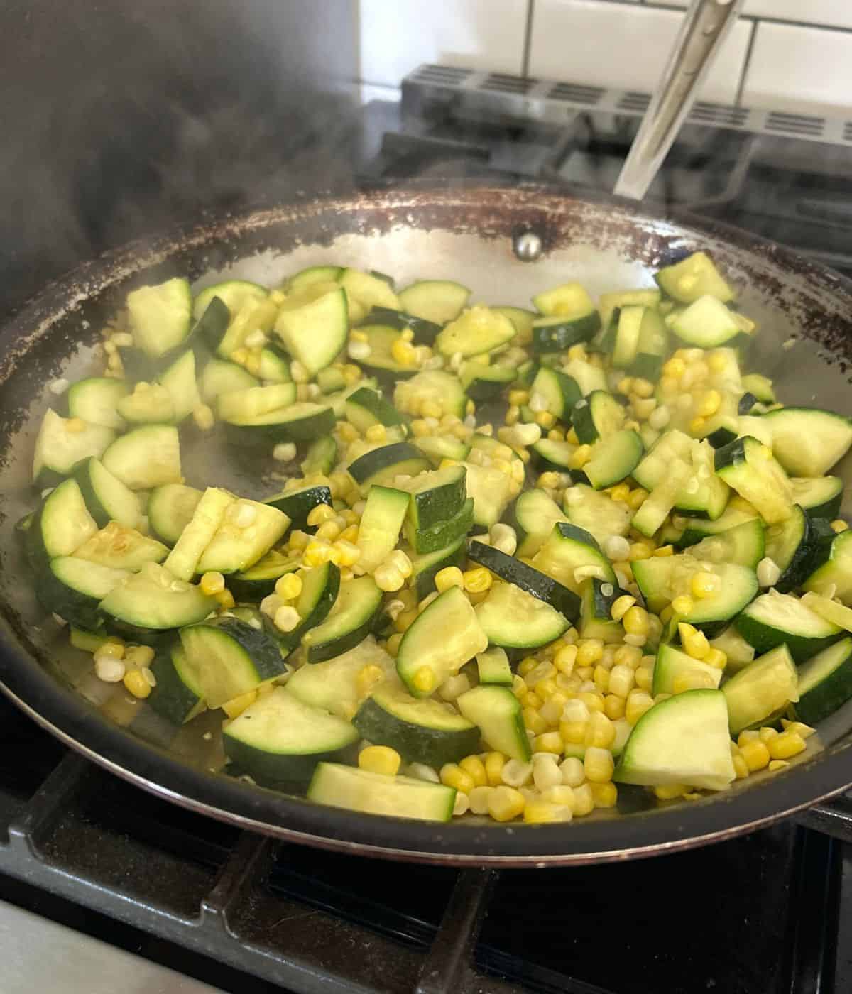 Zucchini and corn in skillet.