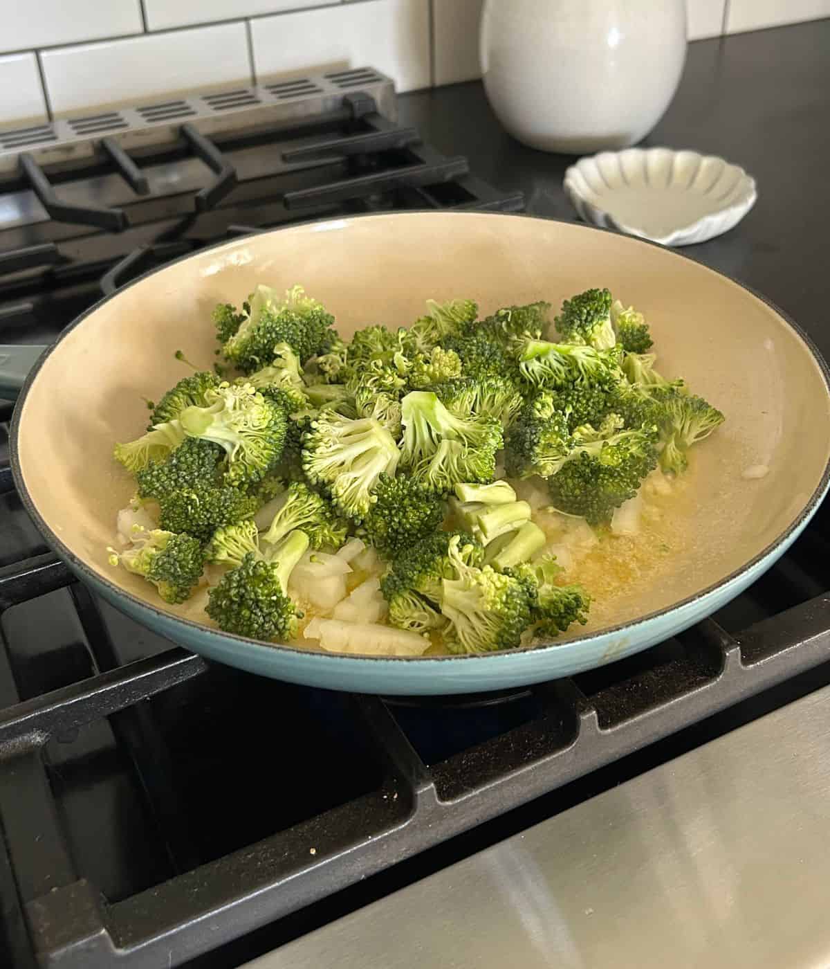 Broccoli and onions in skillet.