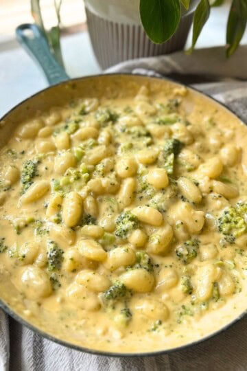 Broccoli cheese gnocchi in skillet.