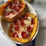 Pizza stuffed spaghetti squash in dish.