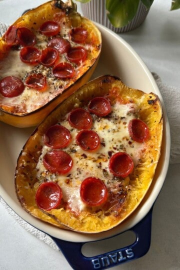 Pizza stuffed spaghetti squash in dish.