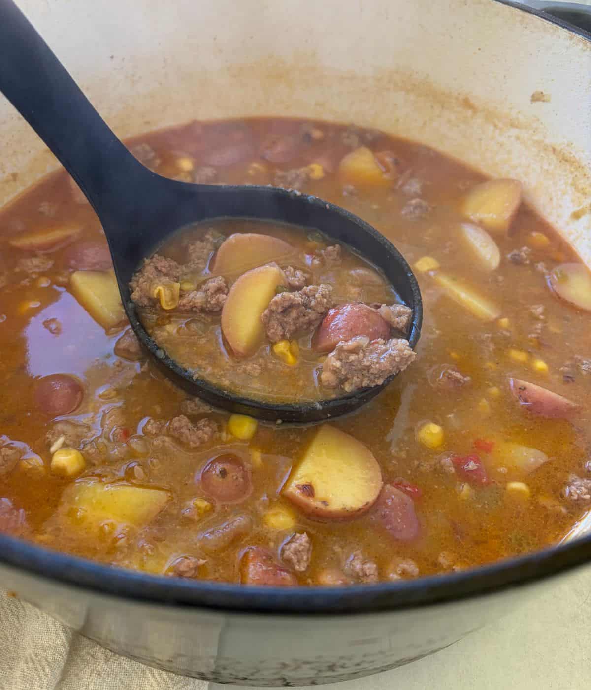 Cowboy soup with ground beef and potatoes in dutch oven.